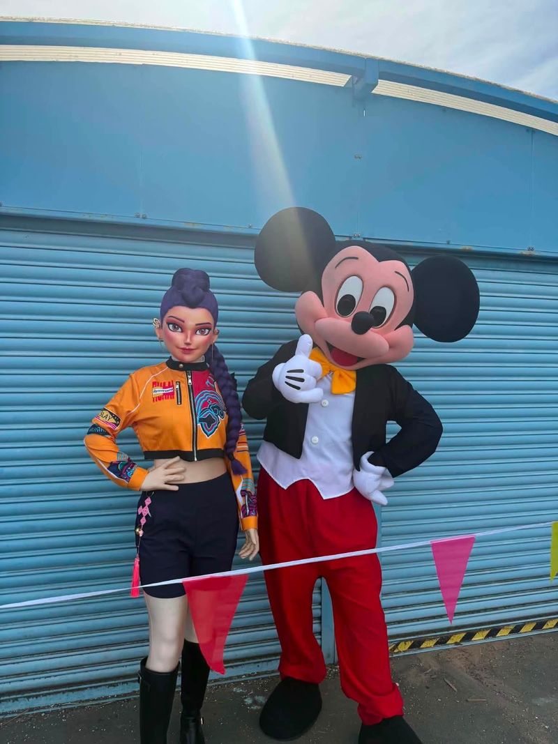 Two look-alike characters posing together at an outdoor event